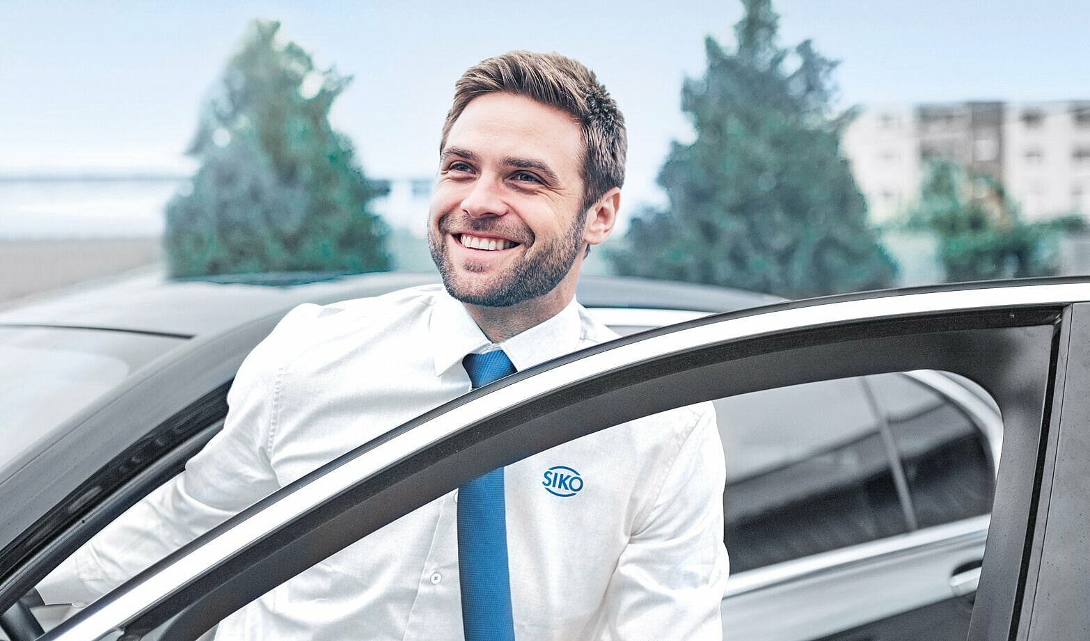 Außendienstmitarbeiter der gerade in sein Auto einsteigt