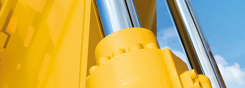 Hydraulic cylinder on yellow construction machine